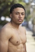 Young mixed race man with bare chest