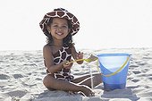 Young mixed race girl playing at beach