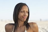 Mixed race woman relaxing at beach