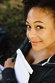 Smiling African woman holding book