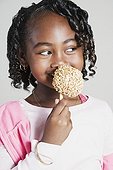 African girl eating candy apple