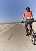 Woman riding bicycle at beach