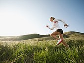 Caucasian woman running in remote field