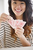 Pacific Islander woman playing cards