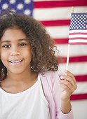 Mixed race girl holding American flag
