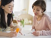 Japanese daughter explaining, medication to mother