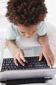 Black boy typing on computer