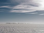 Clouds over distant winter landscape
