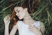 Caucasian woman napping in grass