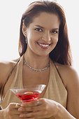 Portrait of smiling woman with cocktail