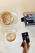 Customer paying for coffee in coffee shop, overhead view