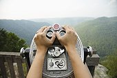 Mid adult woman holding coin operated binoculars,  focus on hands, New River Gorge National River, Fayetteville, West Virginia, USA