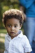 Portrait of preschool boy wearing white shirt looking at camera