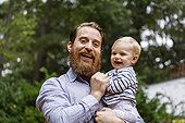Portrait of father and baby girl, outdoors, laughing