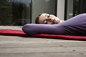 Woman Lying on a Yoga Mat