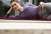 Woman Lying on a Yoga Mat