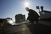 Man Monitoring Laptops and Using Surveillance Equipment