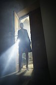Woman in Doorway with Flashlight