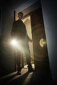 Man in Doorway with Flashlight