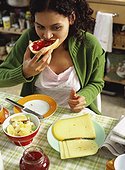 Young woman sitting at breakfast table