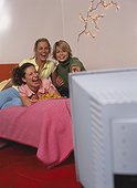 Three young women watching tv