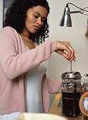 Young woman making coffee