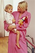 Mother wearing bathrobe, holding daughter