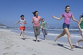 Group of Young People Running on Beach