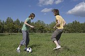 Two Young Men Playing Soccer