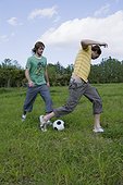 Two Young Man Playing Soccer
