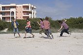 Group of Young People Running on Beach