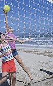 Two Women Playing Beach Volleyball
