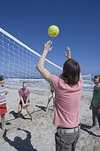 Group Playing Beach Volleyball