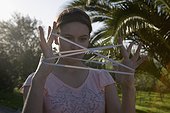 Young Woman Playing Cat's Cradle