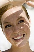Smiling Young Woman Shading Her Eyes