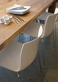 White Dining Chairs at Wooden Table
