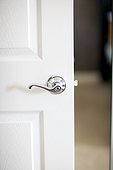 Detail of white door with silver handle