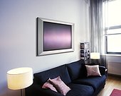 A television is seen above the couch in the living room