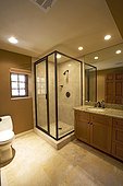 Side view of a toilet and a shower in a neat and clean bathroom