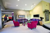 Colorful armchairs and couches are arranged under the spotlights in an exquisite living room