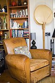 Worn Leather Club Chair by Bookcase