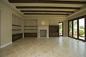 Empty Living Room with Tiled Stone Floor and Built-in Cabinets