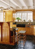 Stone Tile Floor and Wooden Cabinetry in Kitchen