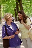 Mother and doughter talking in a park