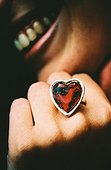 Ring (heart-shaped) at hand of a woman