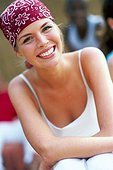 Young laughing woman wearing a scarf on her head