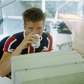 Man drinking coffee in the office