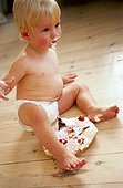 Baby Eating Cake on Floor