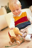 Baby with wooden toy