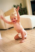 Cheering baby on wooden floor